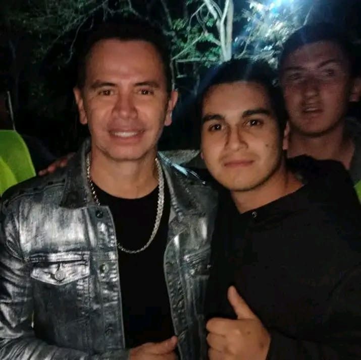 Selfie en primer plano durante una fiesta nocturna, con público y luces de colores detrás
